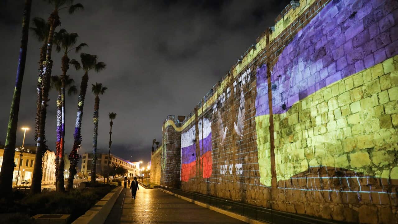 The Ukrainian and Russian flags projected on the walls of the Old City of Jerusalem