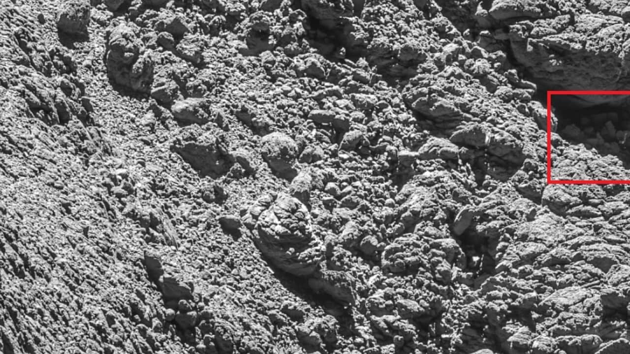 The comet lander Philae in a crack on the right side of the photo (highlighted in red)