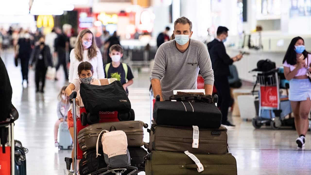 People wearing PPE arriving at Sydney International Airport in Sydney, Monday, November 29, 2021.