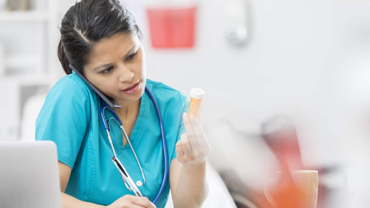 Nurse reads a patient's prescription