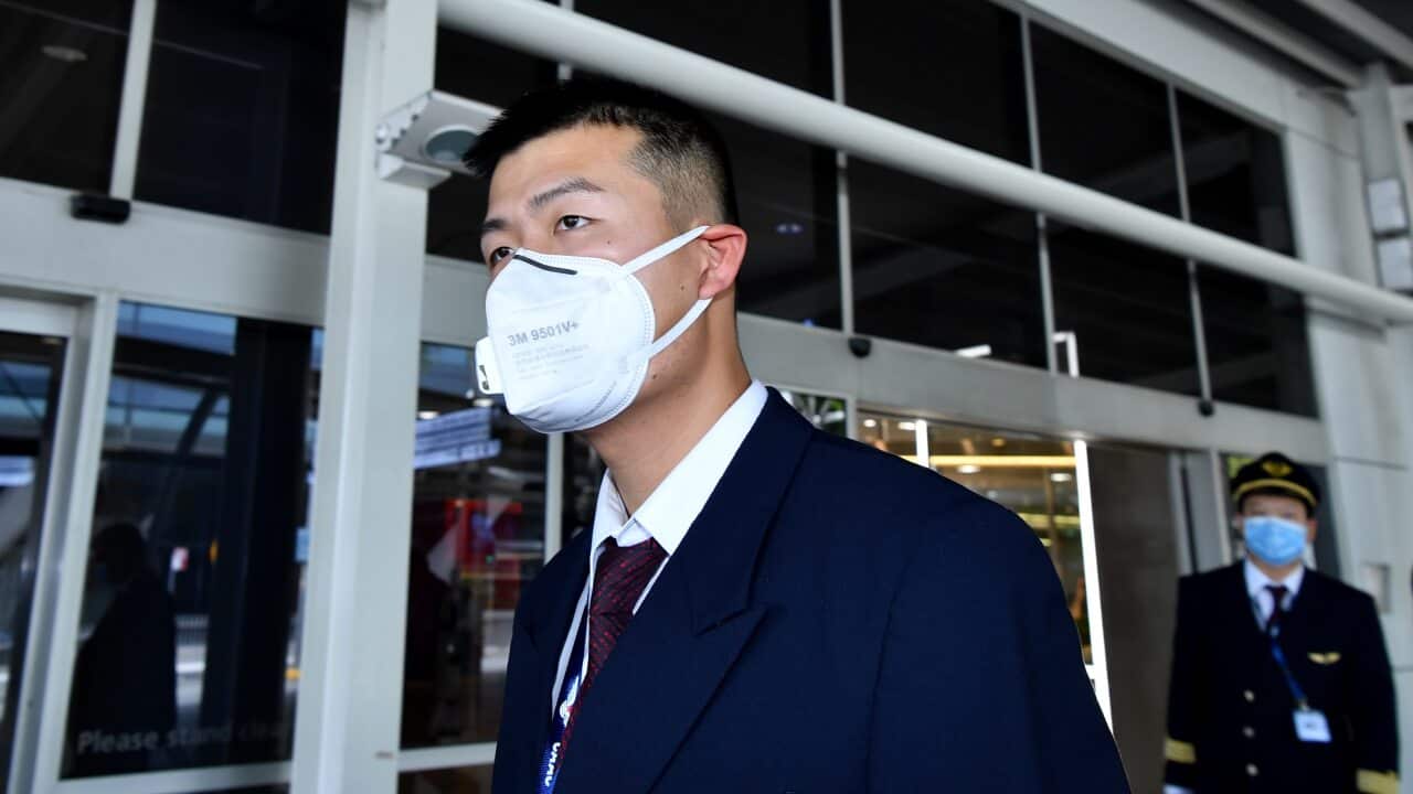 China Eastern Airlines flight crew wear protective masks on arrival at Sydney International Airport.