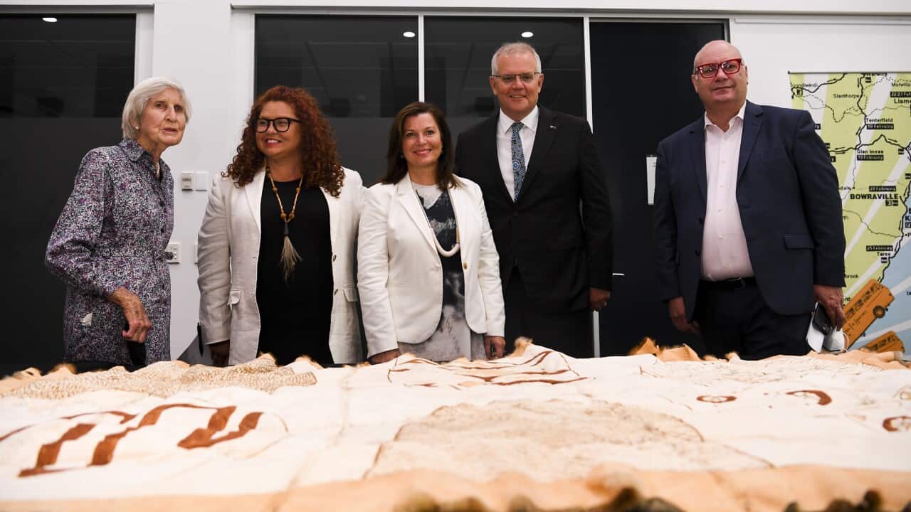 Heather Henderson, Jodie Sizer, Jenny Morrison, Scott Morrison and Craig Ritchie look at Indigenous artefacts.