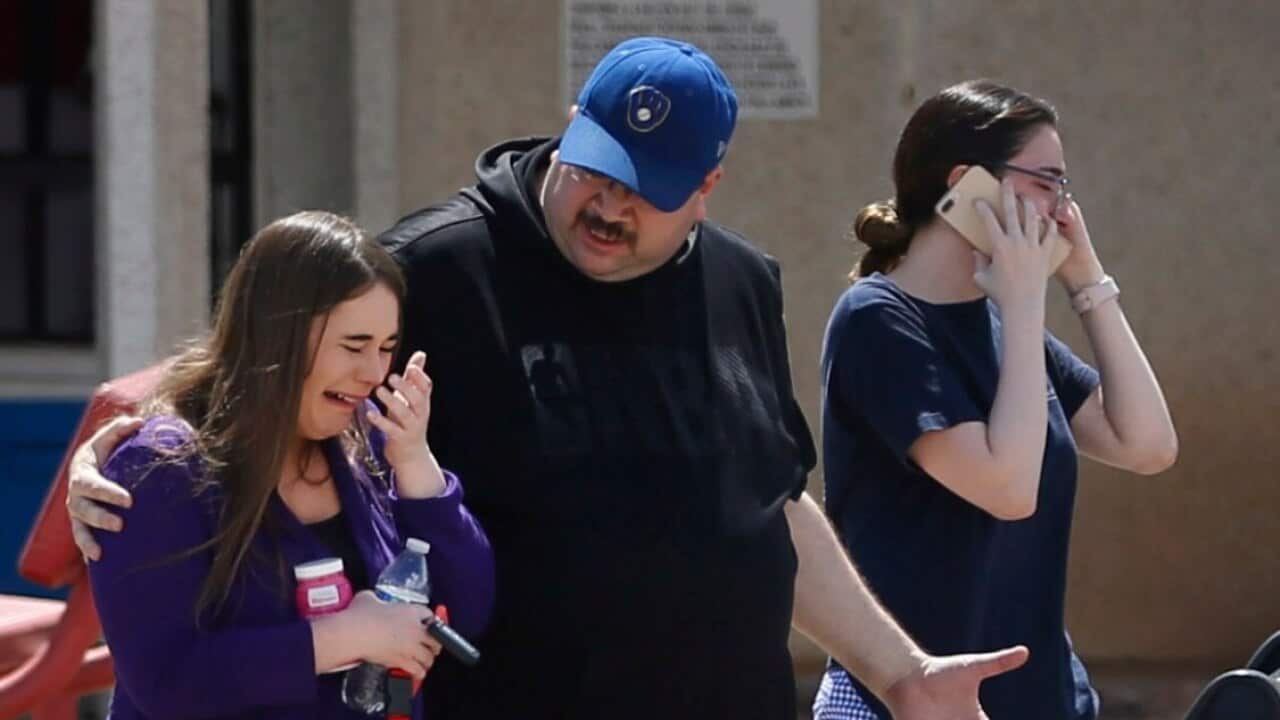 People arrive at MacArthur Elementary looking for family and friends as the school is being used a re-unification center during the aftermath of a shooting