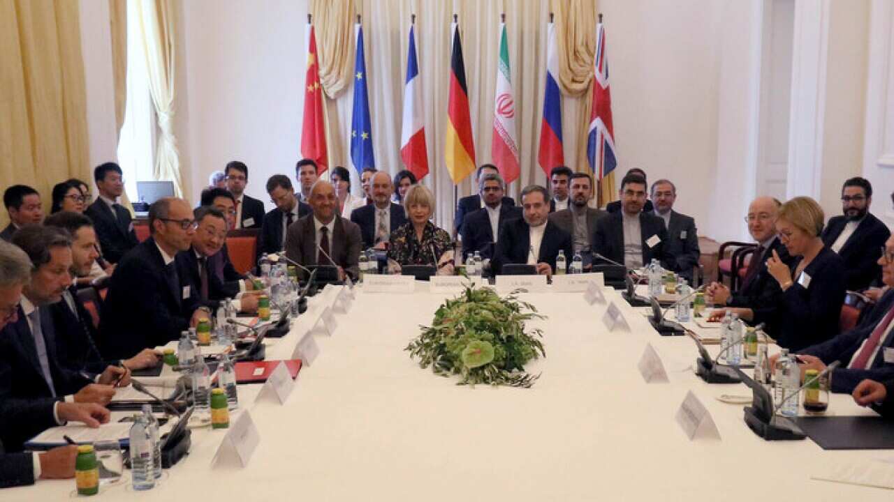 Diplomats wait for a bilateral meeting as part of the closed-door nuclear talks with Iran at a hotel in Vienna
