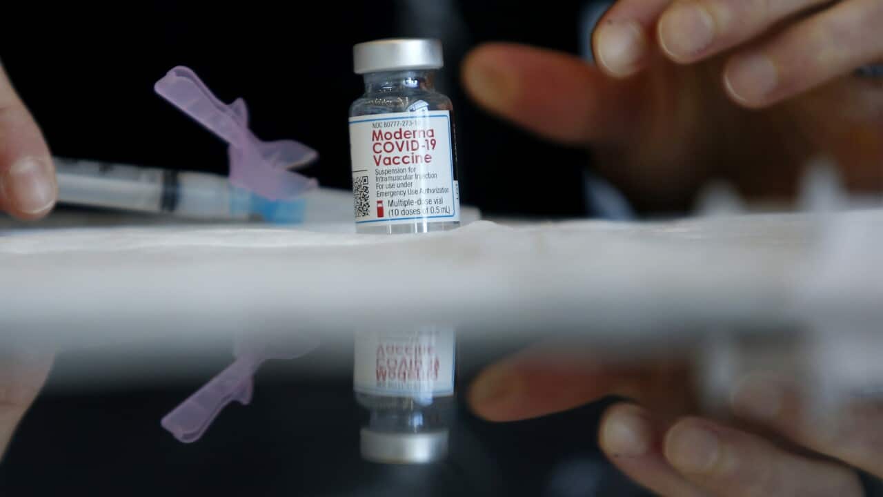 A nurse draws up a dose of the Moderna vaccine.