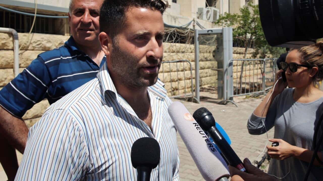 Lebanese father Ali al-Amin speaks to journalists