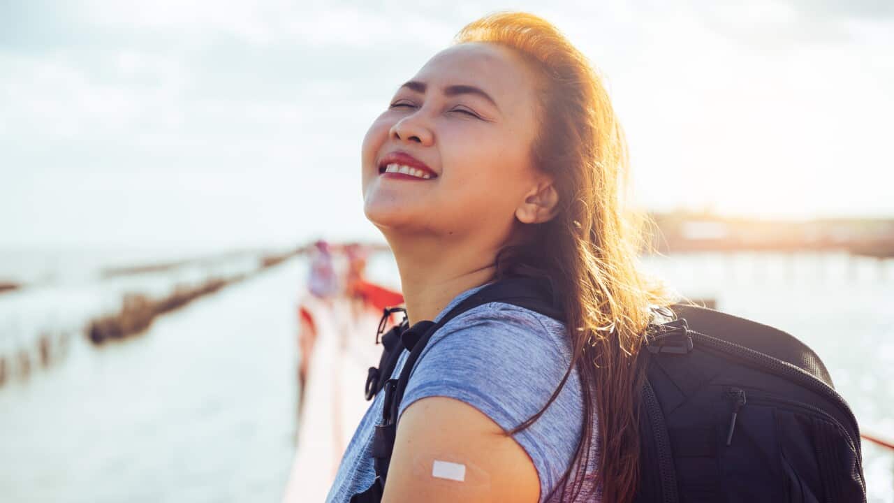 the happiness emotional of the woman when her traveling after vaccination during COVID-19 pandemic