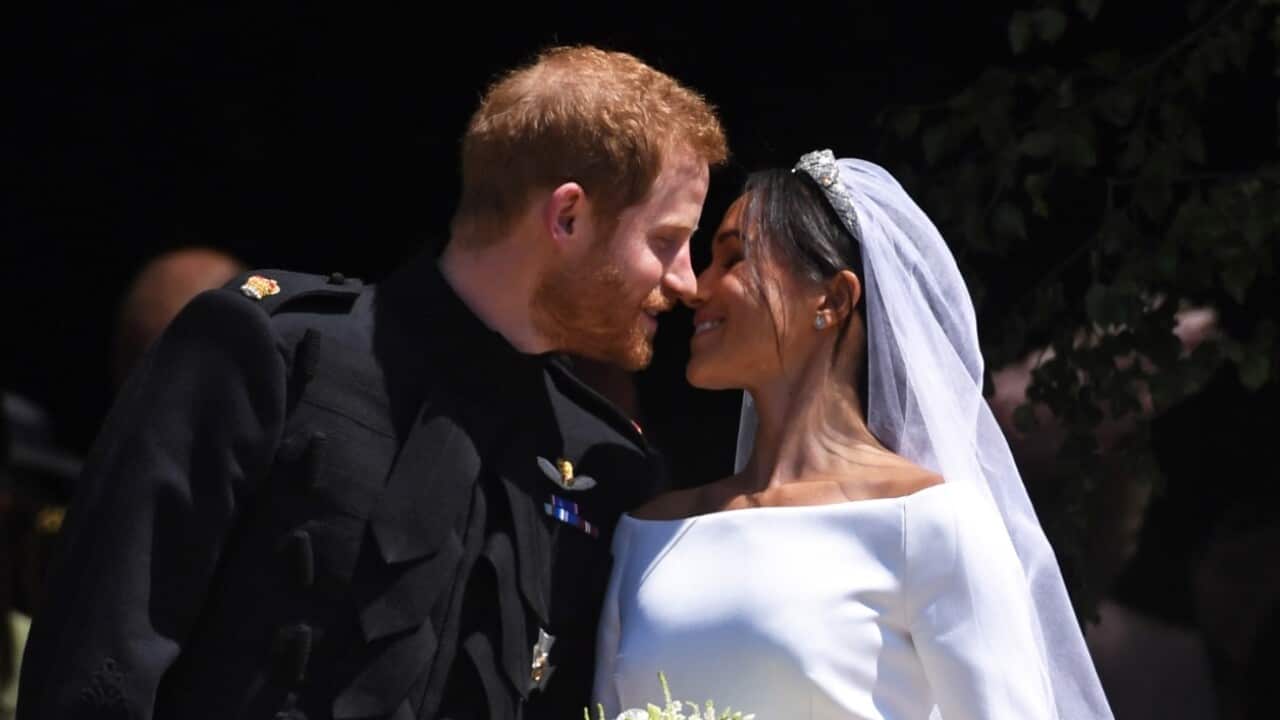 Britain's Prince Harry (L), Duke of Sussex and Meghan (R), Duchess of Sussex exit St George's Chapel in Windsor Castle
