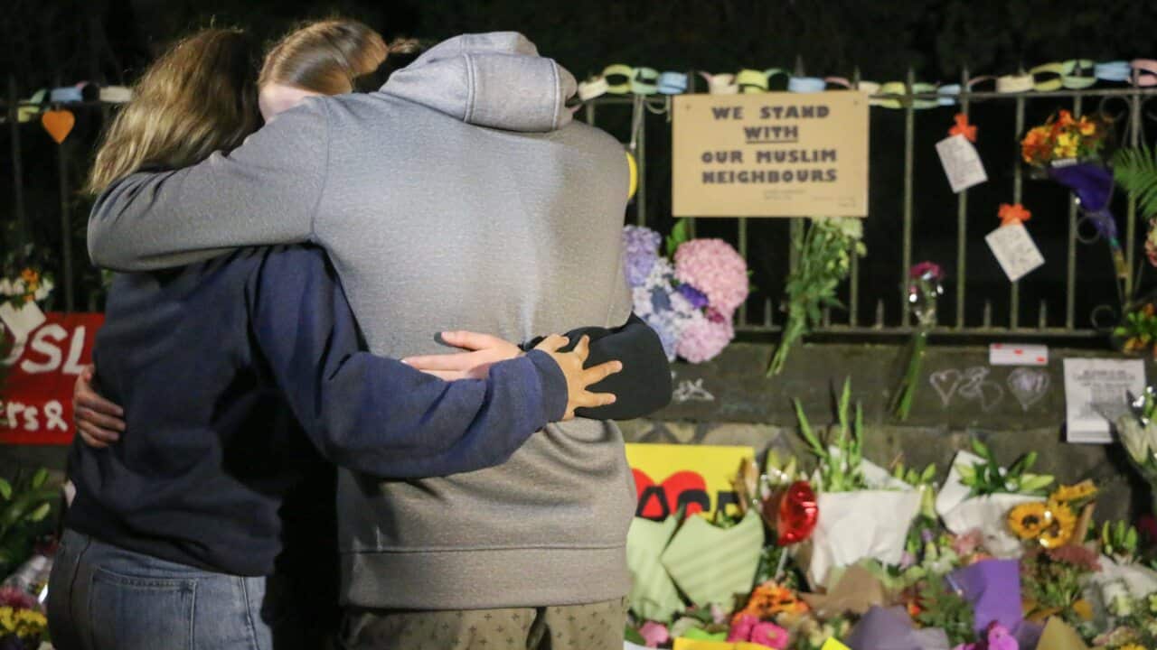 People seen comforting themselves while paying respect to the victims of the Christchurch mosques shooting.
