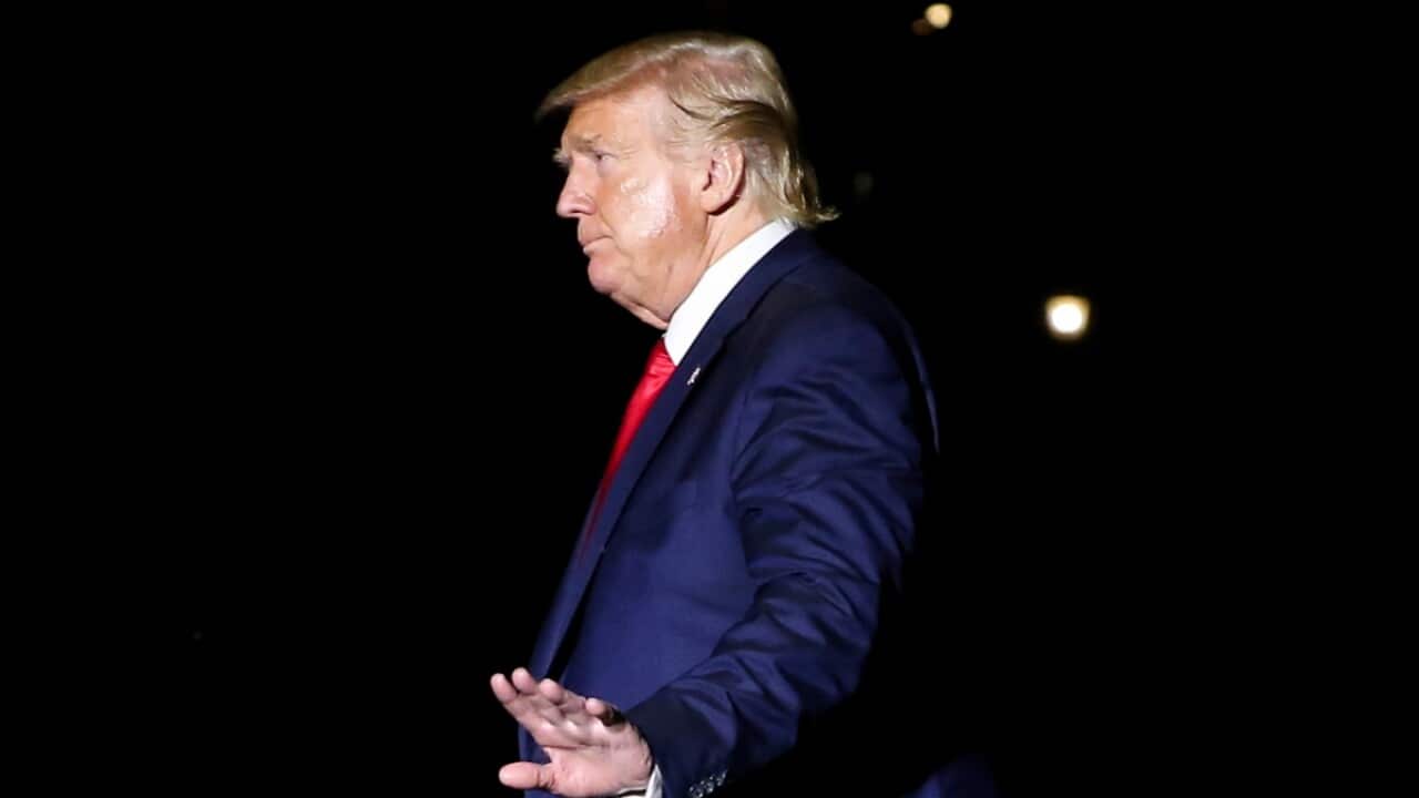 US President Donald Trump walks on the South Lawn of the White House