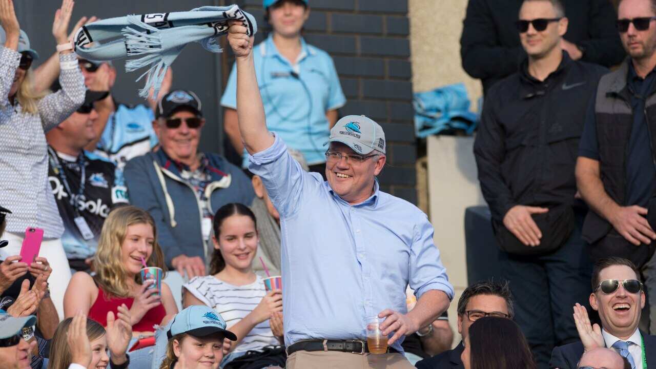 Newly reelected Prime Minister Scott Morrison waves to the crowd during the Round 10 NRL match between the Cronulla Sharks and the Manly Sea Eagles