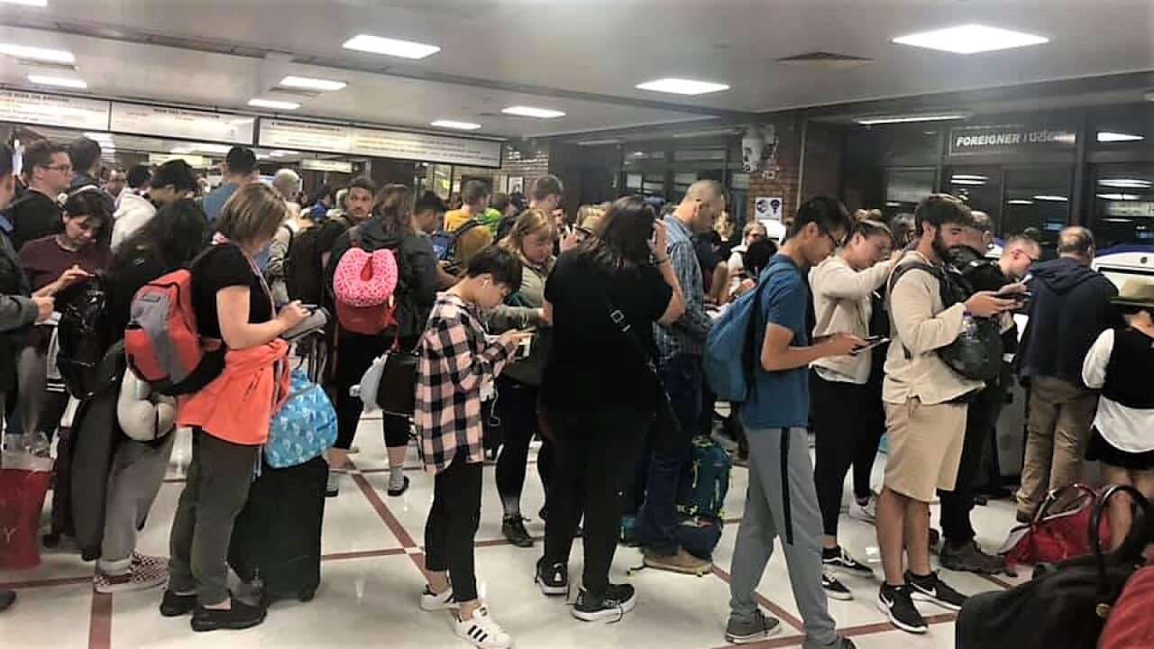 Visitors queue Kathmandu's international airport.