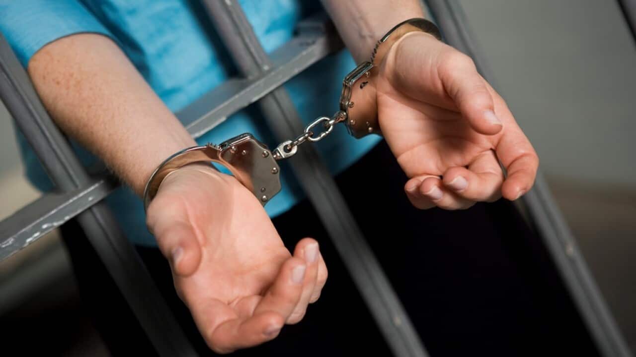 Criminal handcuffed to bars in jail