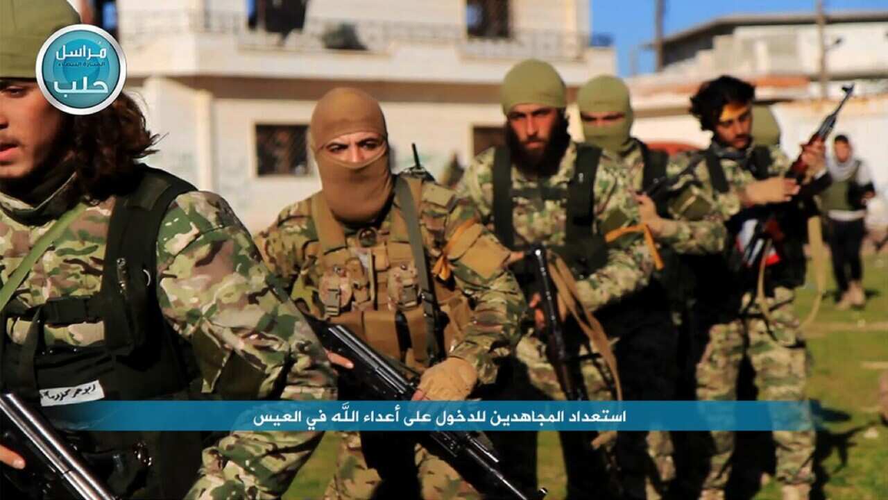 This file photo posted on the Twitter page of Syria's al-Qaida-linked Nusra Front shows fighters from al-Qaida's branch in Syria, the Nusra Front