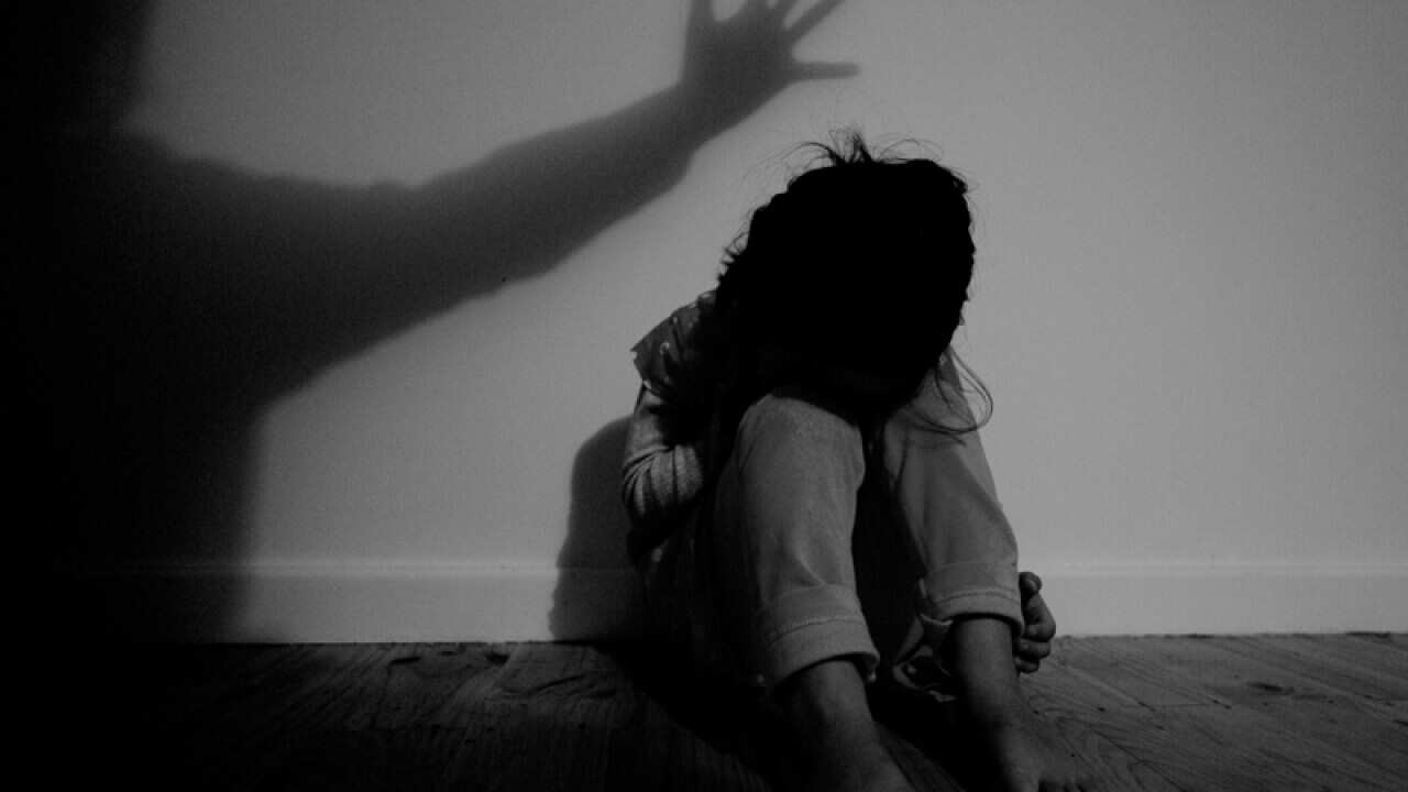 A girl poses for photographs to illustrate the topic of child abuse