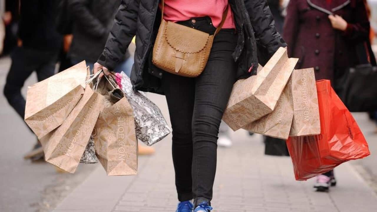 This is a file image of a woman carrying shopping bags.