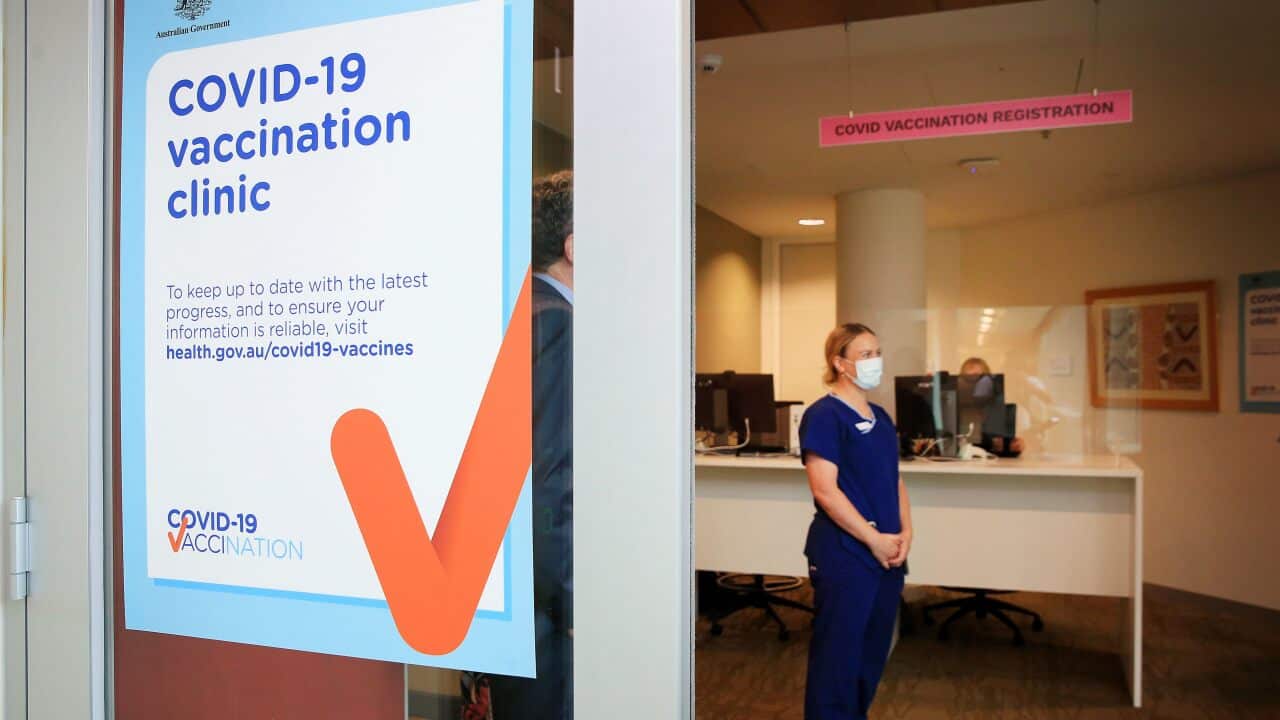 A COVID-19 Vaccination Clinic sign is seen as nurse Grace Gibney waits to receive one of the first Pfizer coronavirus vaccines at Austin Health in Melbourne