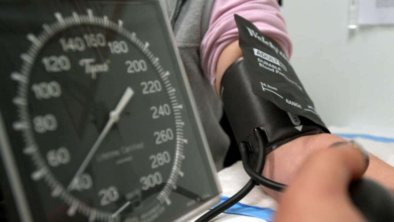 A patient has her blood pressure checked
