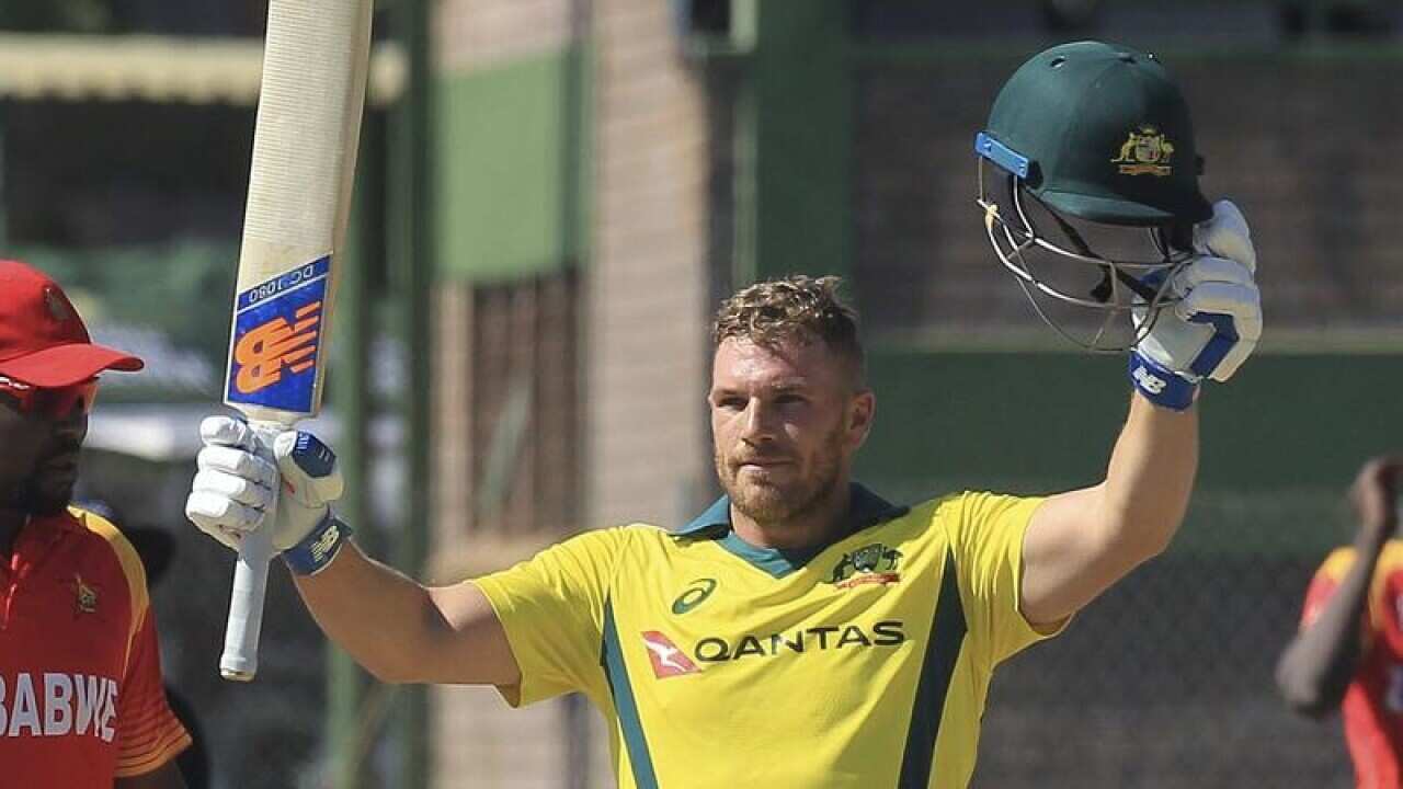 Australian batsman Aaron Finch celebrates scoring 100.