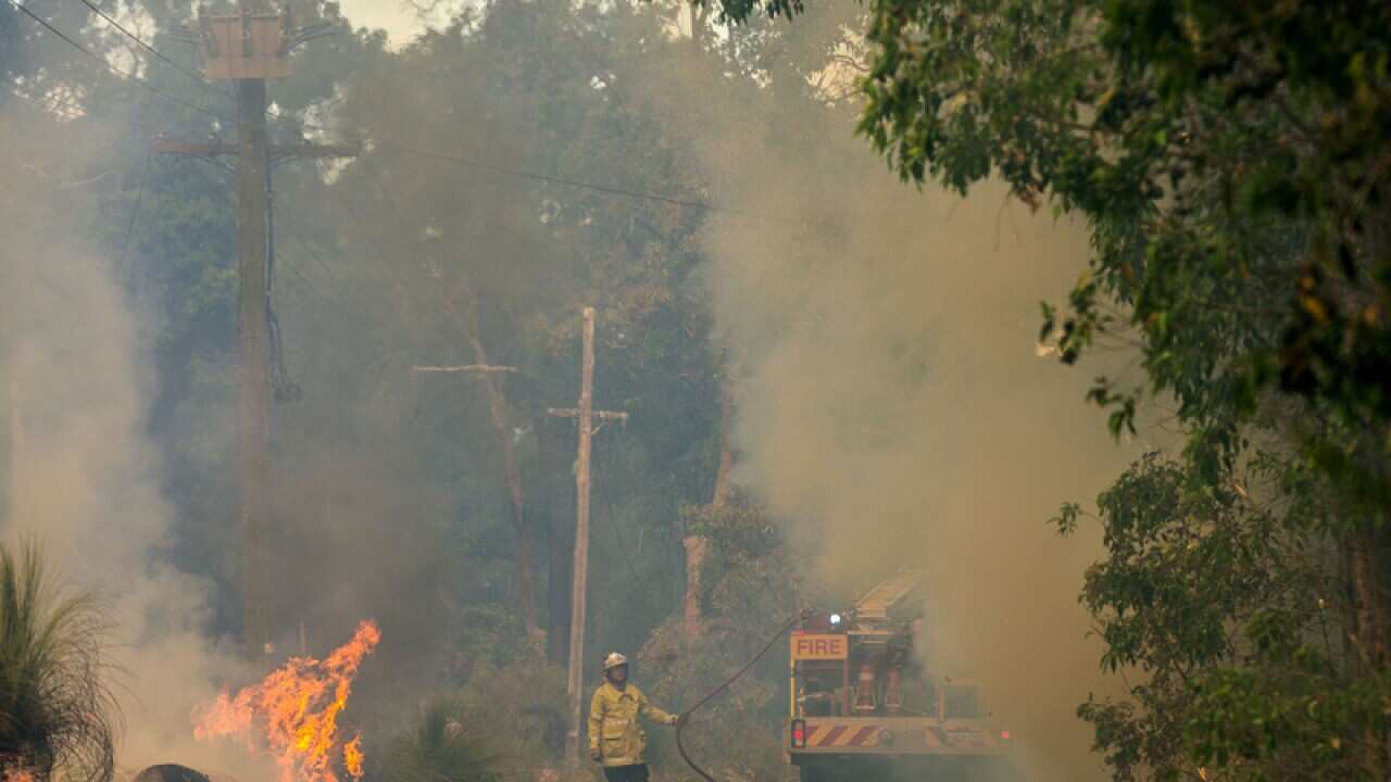 A firefighter battles a blaze in Perth