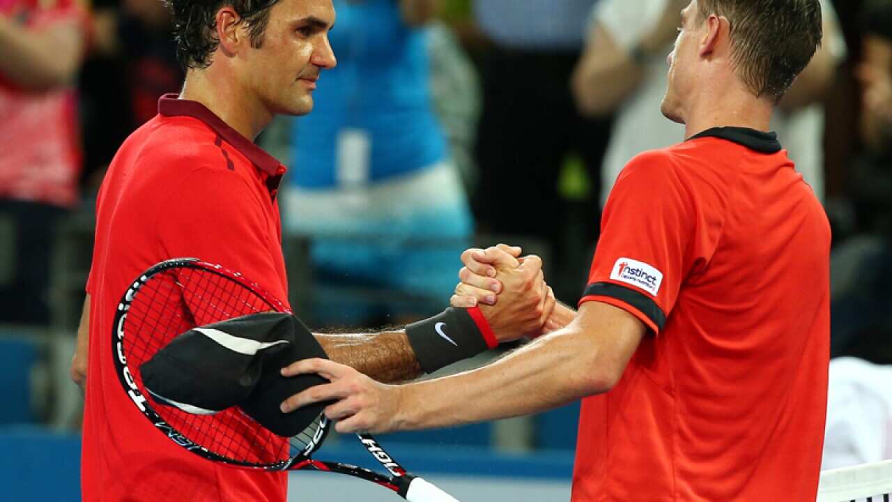 Roger Federer (L) and John Millman