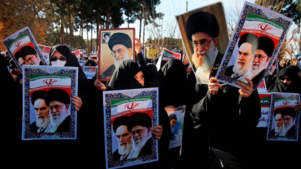 Pro-government demonstrators hold posters of Iran's supreme leader and Iran's founder of the Islamic Republic. 
