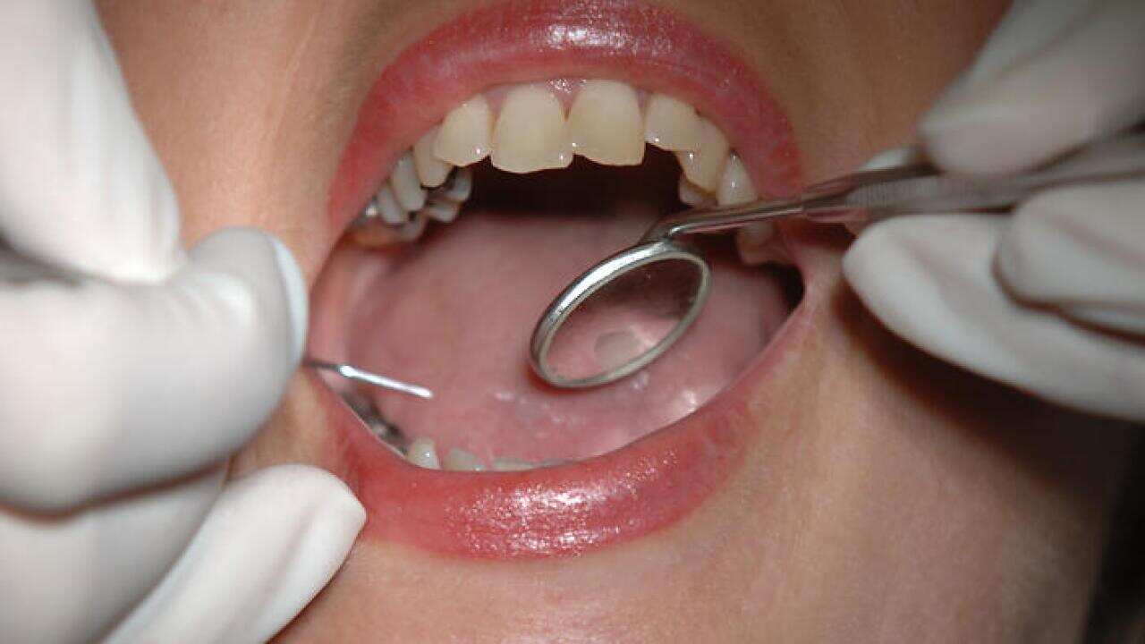 A patient undergoes treatment from her dentist