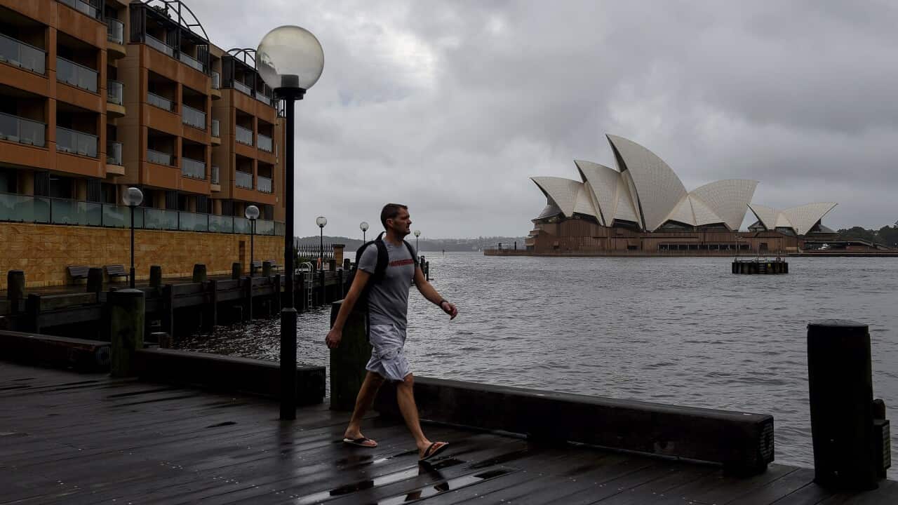 Members of the public walk past the Sydney Opera House in Sydney, Sunday, March 6, 2022.