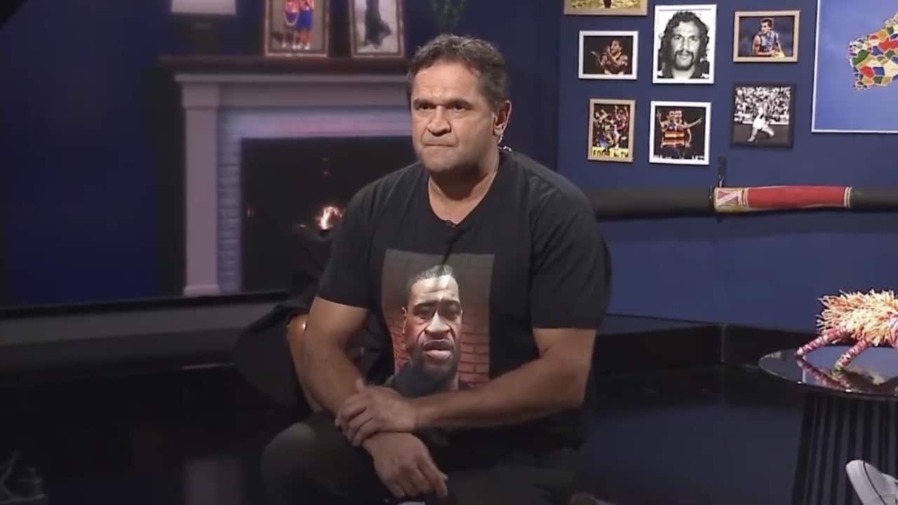 AFL great, Nicky Winmar takes a knee during Yokayi Footy Show.
