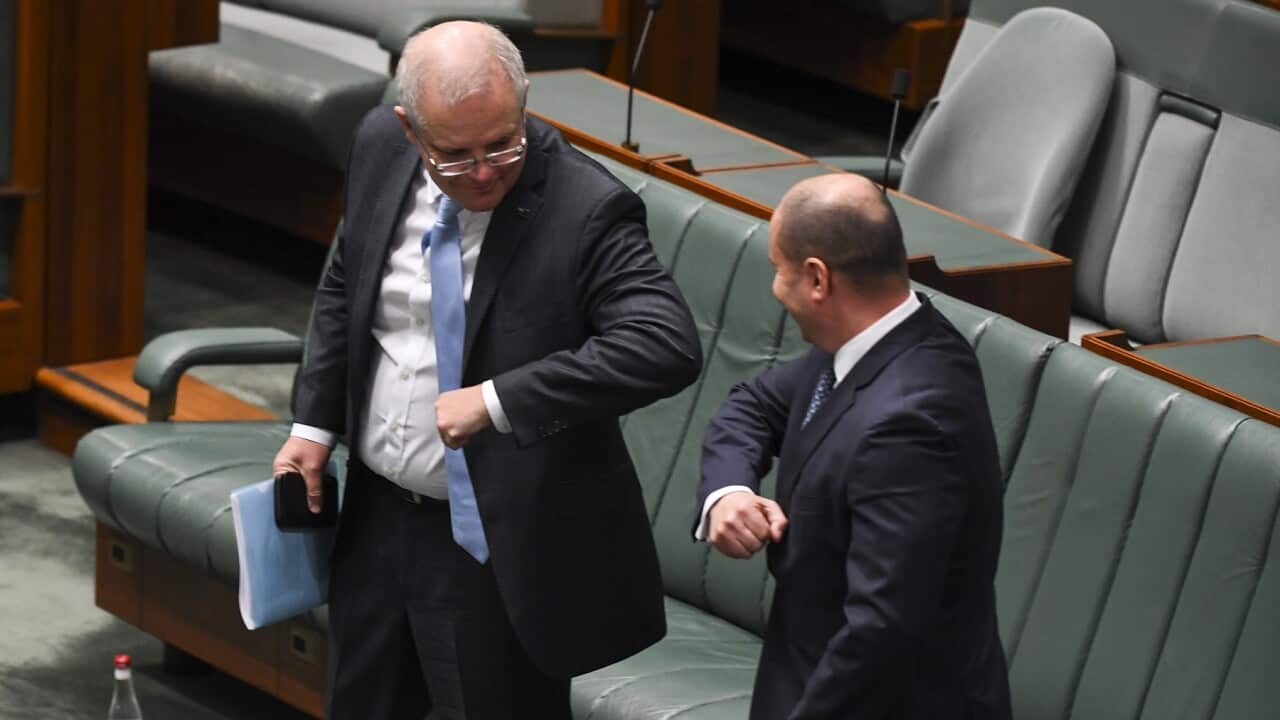 Scott Morrison and Josh Frydenberg elbow bump after introducing the Coronavirus Economic Response Package