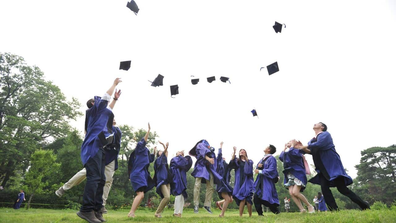 Students throwing hats