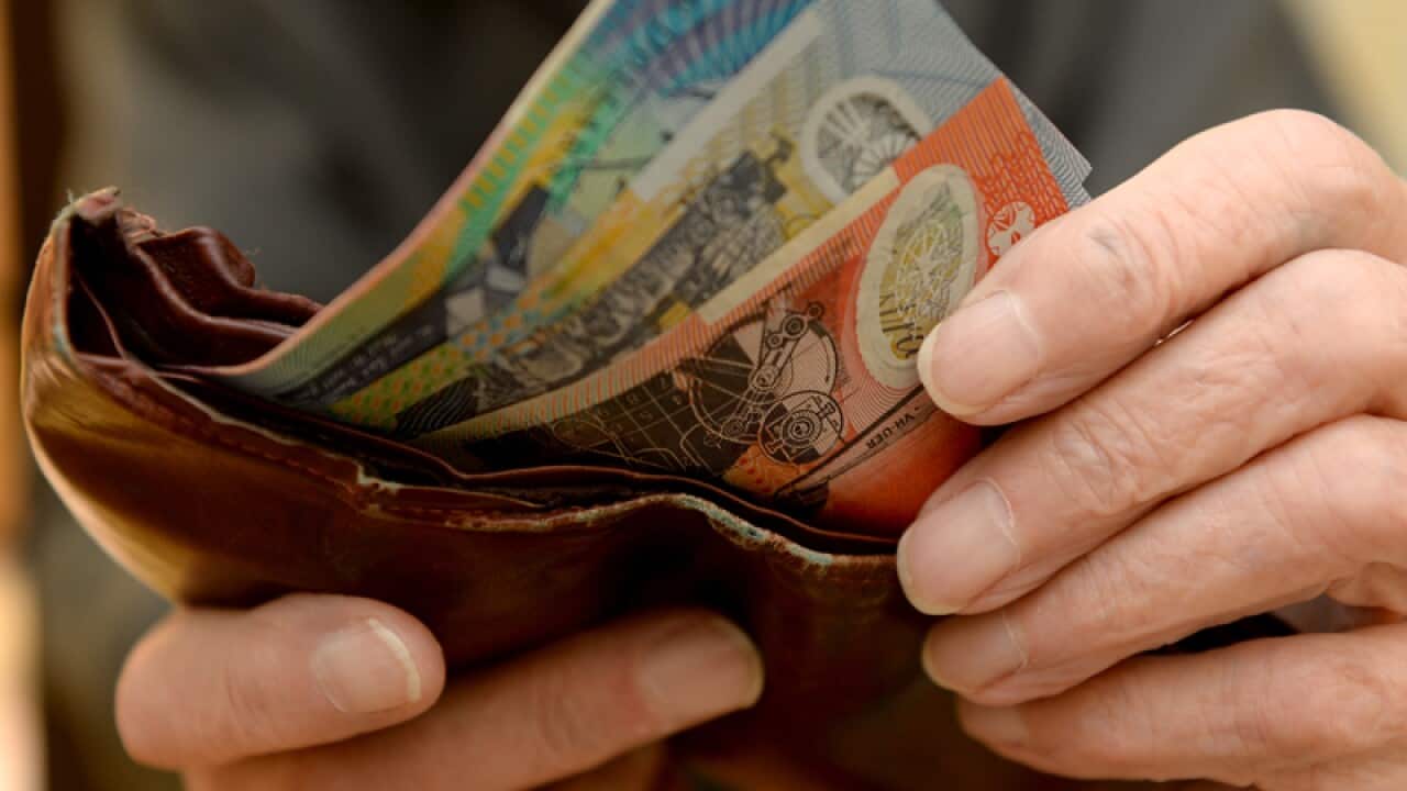 Money is taken out of a wallet