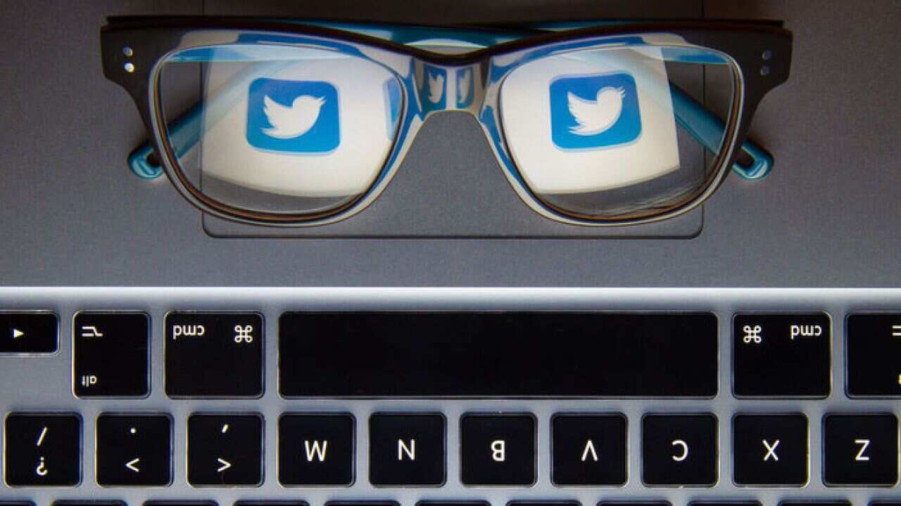 Twitter bird logo reflected in a pair of glasses.