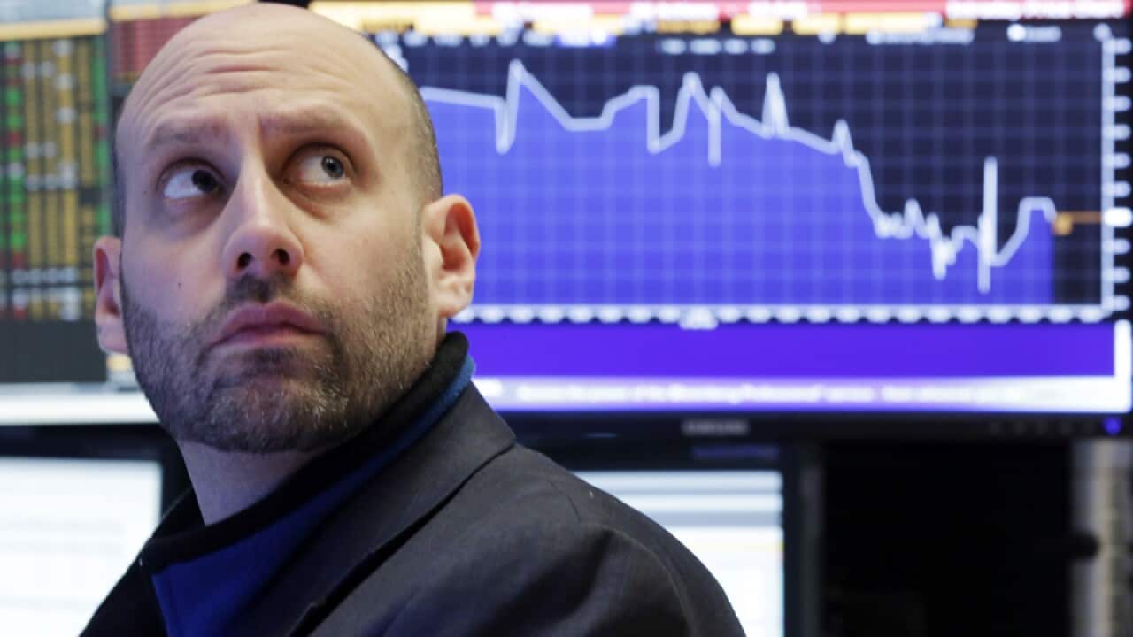 A specialist works on the floor of the New York Stock Exchange