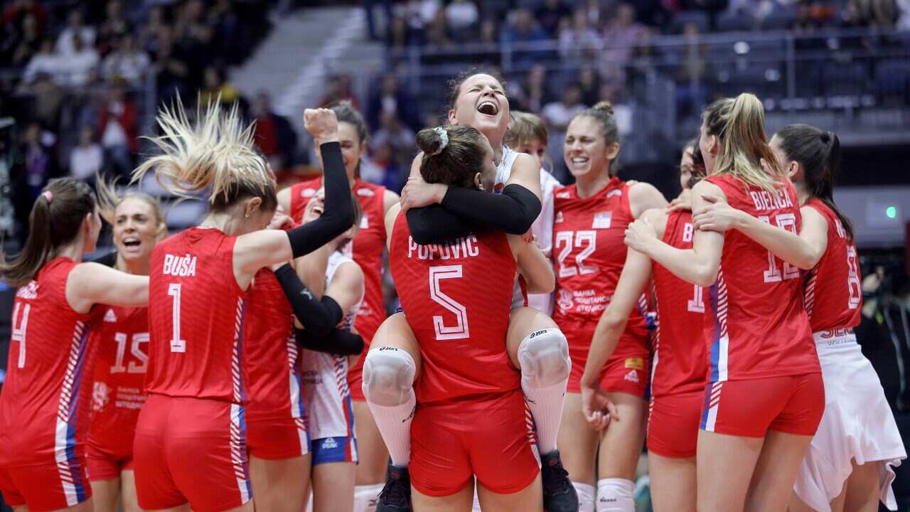 Serbia's national team players celebrate after winning the 2022 Volleyball Women's World Championship semifinal match against the USA in Gliwice, Poland