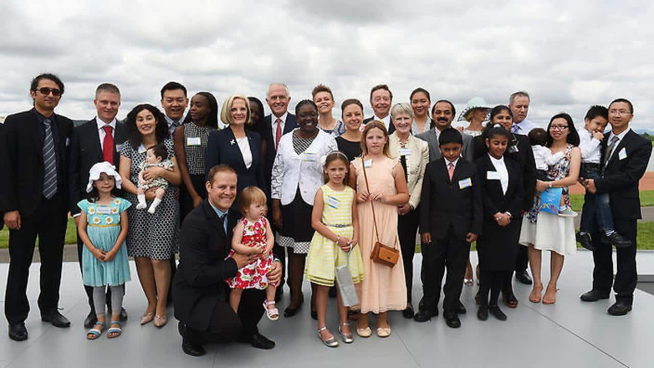 Prime Minister Malcolm Turnbull (C) with newly sworn Australian citizens at an Australia Day Citizenship Ceremony. (AAP)