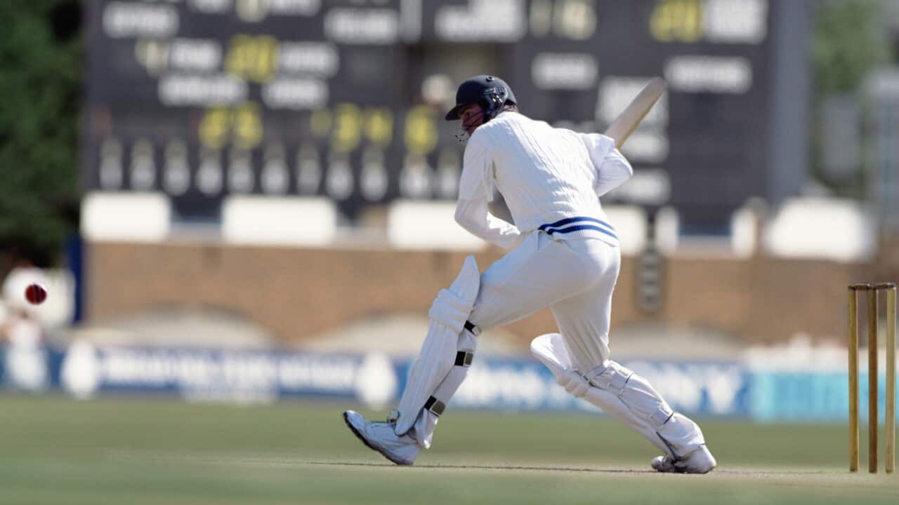 A batsman preparing to hit a cricket ball