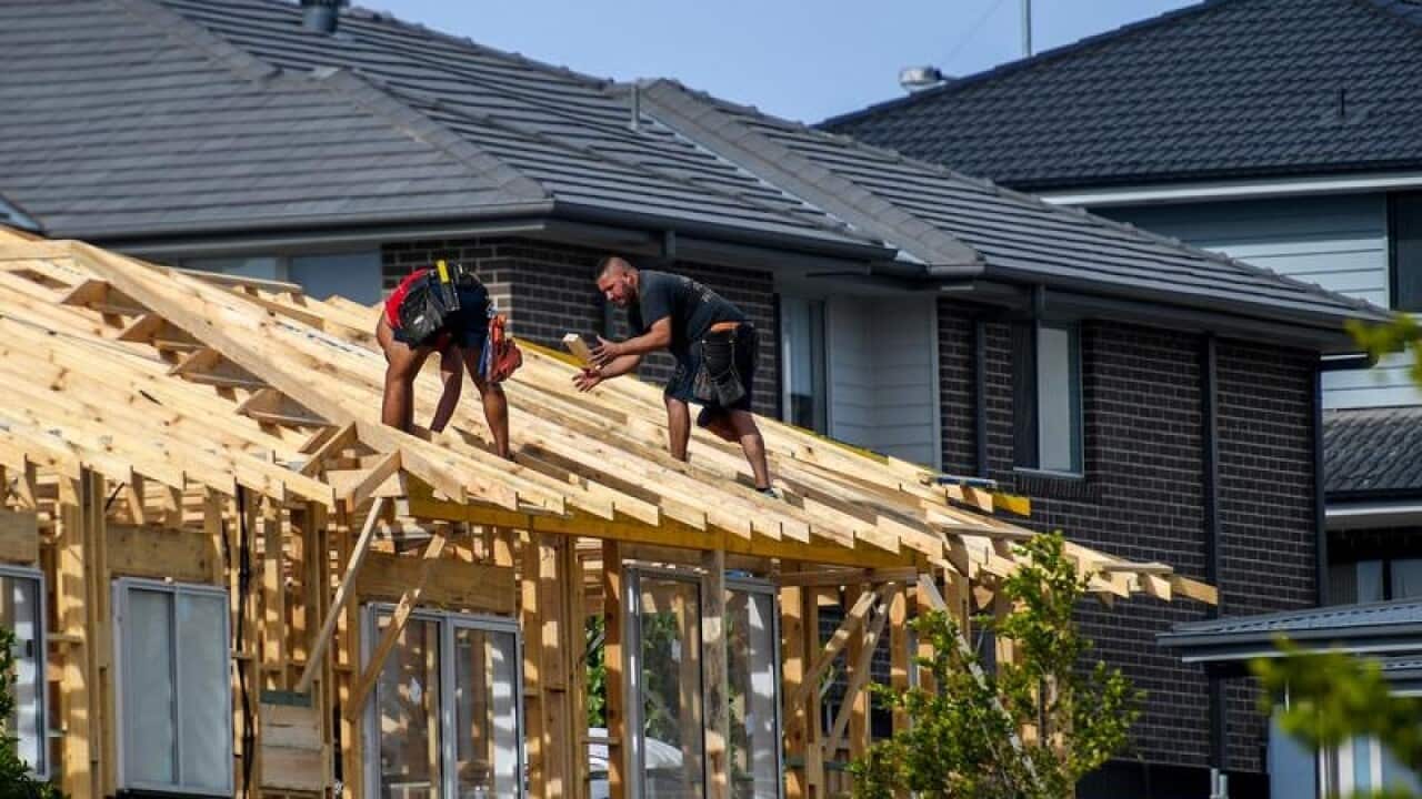 Workers on the roof of a house under construction
