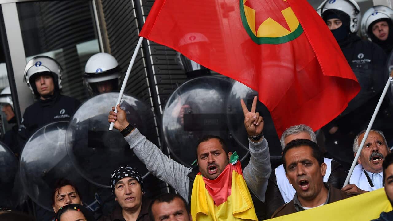 Protesters wave a Kurdistan Workers' Party (PKK) flag at the European Parliament in Brussels, Oct 7, 2014 to support the Syrian Kurdish town of Kobane besieged by Islamic State. (EMMANUEL DUNAND/AFP/Getty)