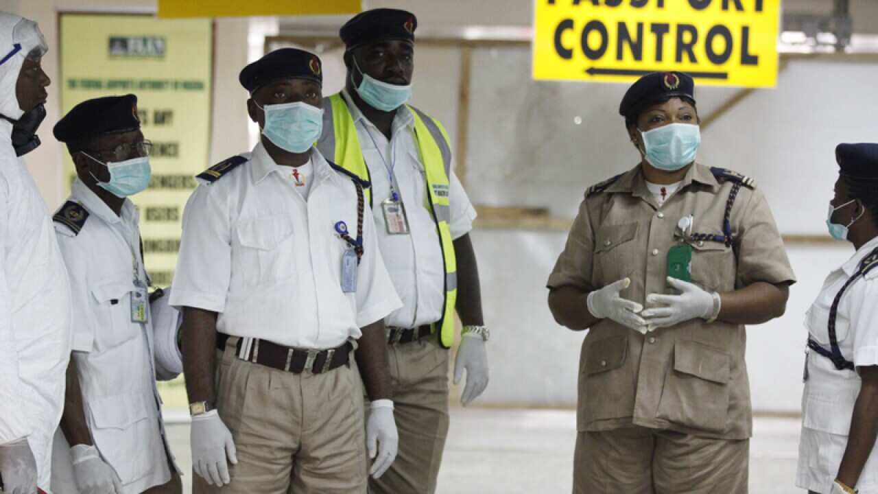 Nigerian health officials wait to screen passengers