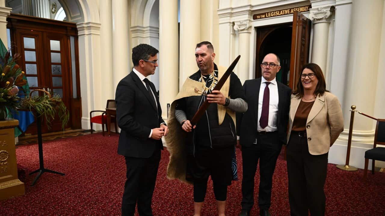 Travis Lovett shows Victorian Opposition Leader Brad Battin a message stick after arriving at Parliament House (AAP).