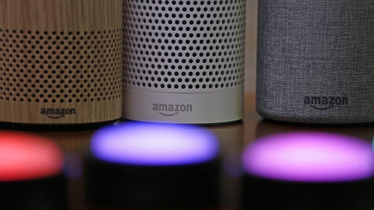 Three vertical round speakers on a shelf. Each has Amazon written near the bottom.
