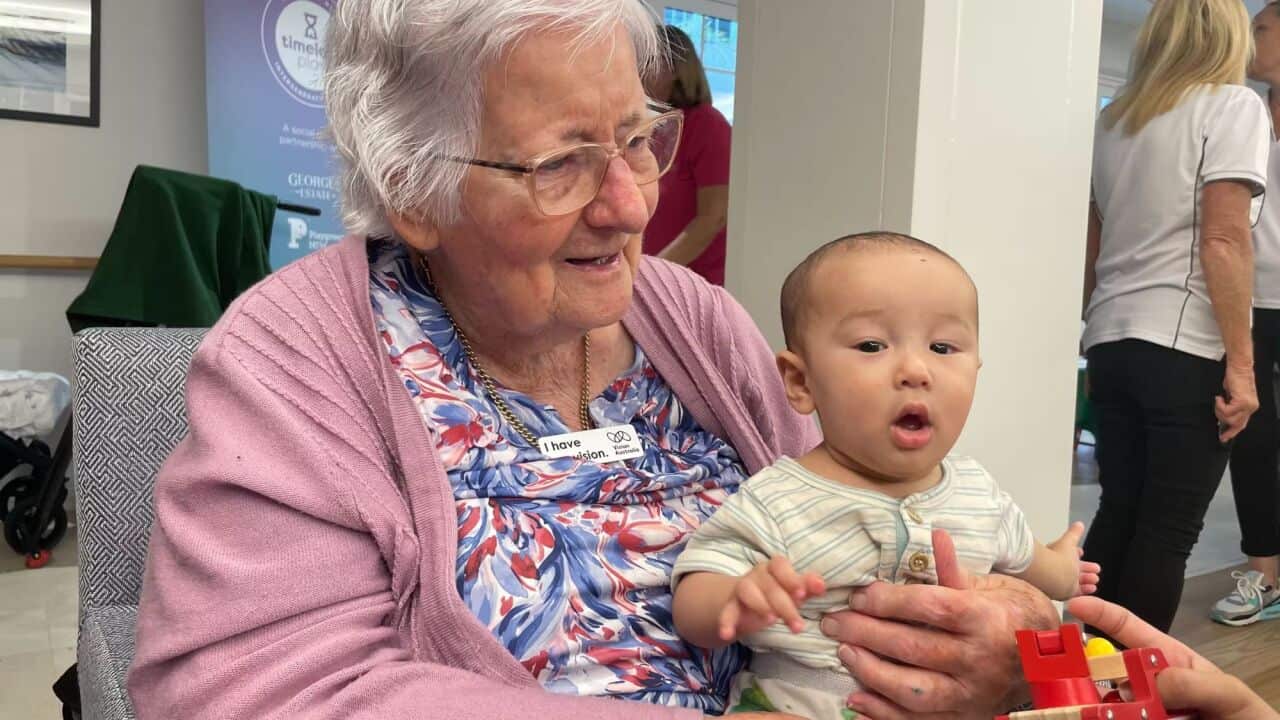 Carmel Bollard enjoys time with Charlie during a playgroup in Sydney's south