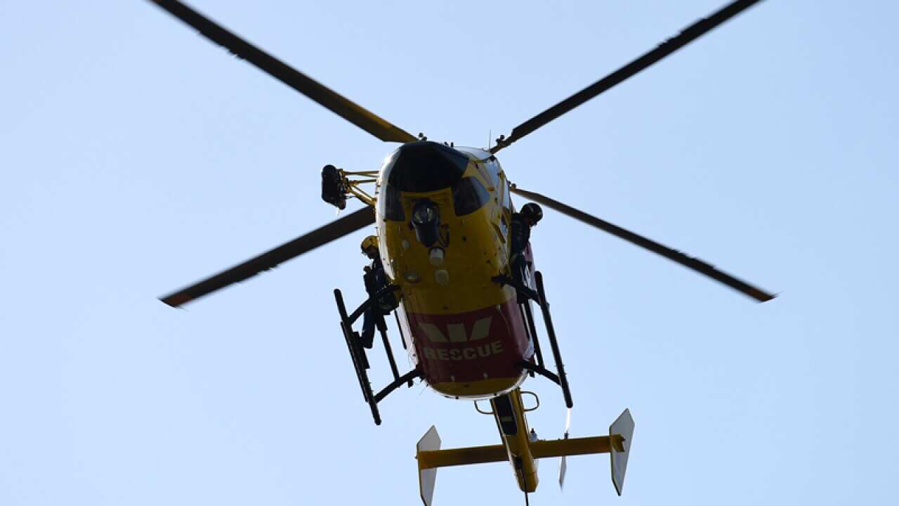 Paramedics arrive aboard a rescue helicopter