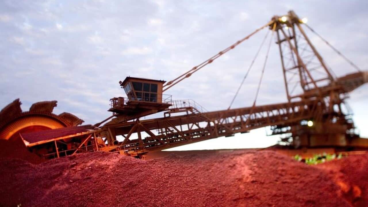 iron ore mining equipment silhouetted against dusk sky