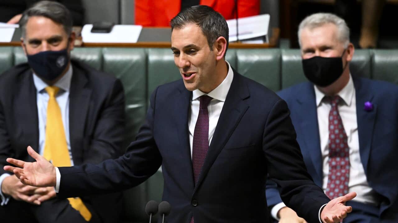 Jim Chalmers in a suit delivering a speech to parliament.
