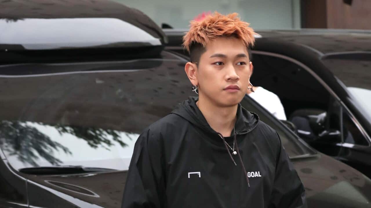 South Korean singer Crush wearing a blck hoodie