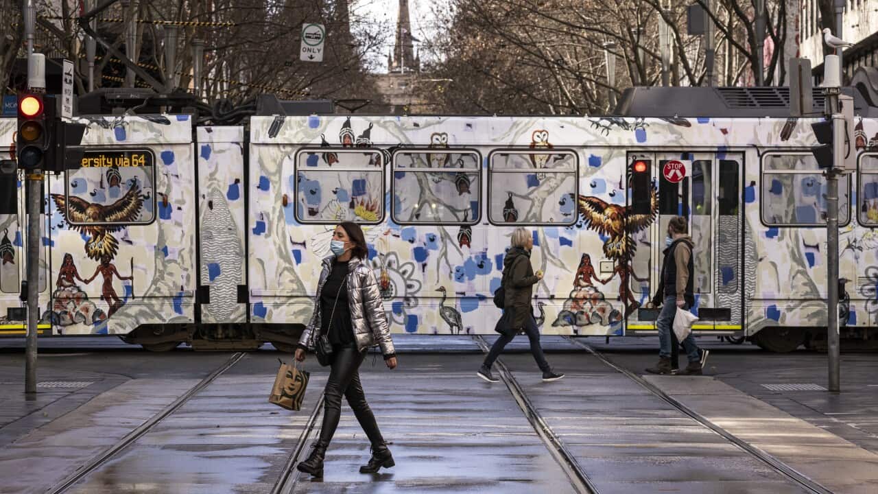 People are seen crossing Bourke Street Mall in Melbourne, Wednesday, July 28, 2021.