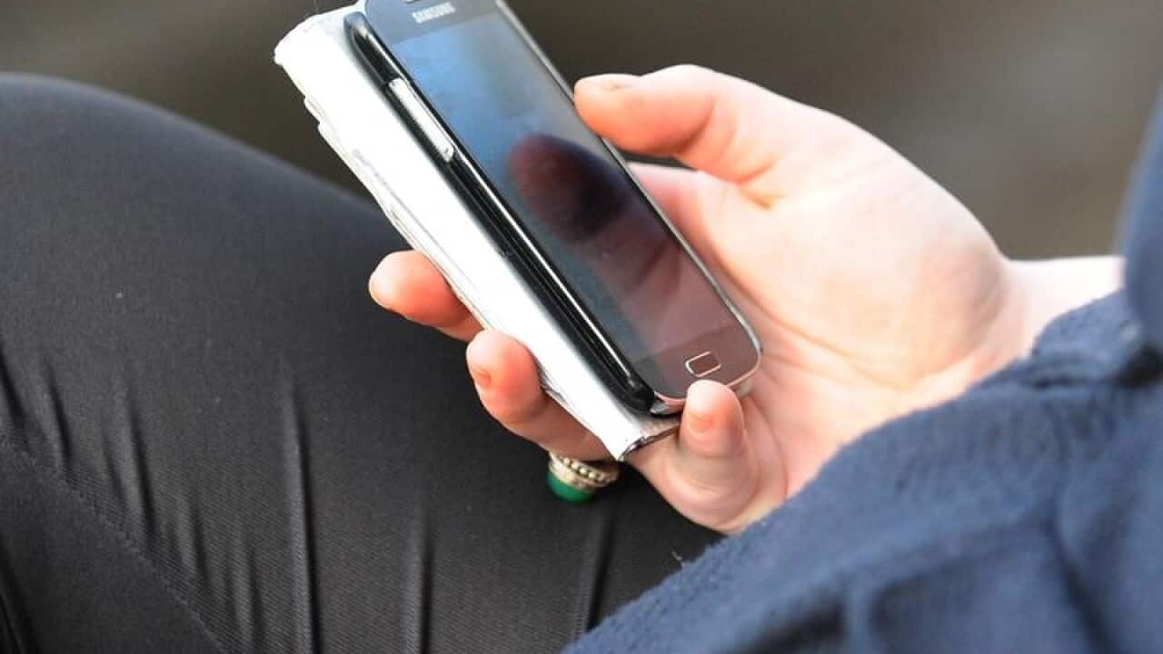 File photo dated 11/10/14 of a person using a mobile phone.