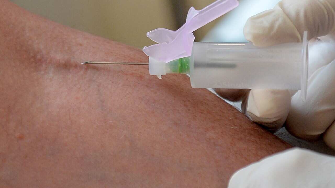 A nurse taking blood